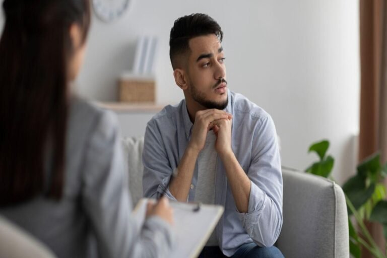 Man discussing compulsive sexual behavior with a therapist during a counseling session